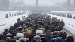 On the 75th anniversary of the battle that lifted the Siege of Leningrad in World War 2, people walk in snowfall to the Motherland monument to place flowers at the Piskaryovskoye Cemetery where the victims were buried, St. Petersburg, Russia, January 26, 2019