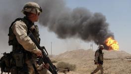 A US Army soldier watching a burning oil well at Rumaila oil field in Iraq in April 2003. Photo: US Navy
