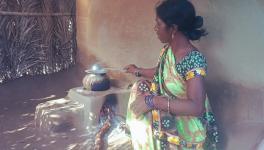 A glimpse of a woman cooking on a smoky wood fire (Photo - Yusha Rahman, 101Reporters)