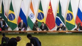 China's President Xi Jinping, left, Russia's President Vladimir Putin, second from left, Brazil's President Jair Bolsonaro, center, India's Prime Minister Narendra Modi, second from right, and South Africa's President Cyril Ramaphosa leave after a meeting during the BRICS emerging economies, Brasilia, Brazil