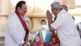 Sri Lankan President Gotabaya Rajapaksa (R) greeting the newly-elected Prime Minister Mahinda Rajapaksa (L) at the swearing-in ceremony at Kelaniya Buddhist temple in Colombo, Aug 9, 2020