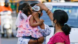 Apr 03 (ANI): A woman gives water to her child in respite from the heatwave on a hot summer day, in New Delhi on Sunday. 