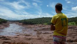 A boy looks at the mud that reached the city of Brumadinho, in Brazil, after a dam at an iron-ore mine collapsed in January 2019. Hundreds were killed in the disaster.