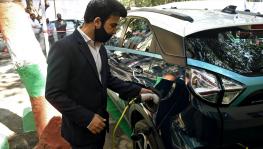 A resident member tests a new electric vehicle charging station, at Vasant Kunj, in New Delhi