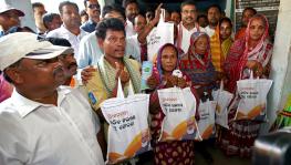 Dhamendra Pradhan distributing rice to beneficiaries at PMGKAY PDS Center in Dhenkanal