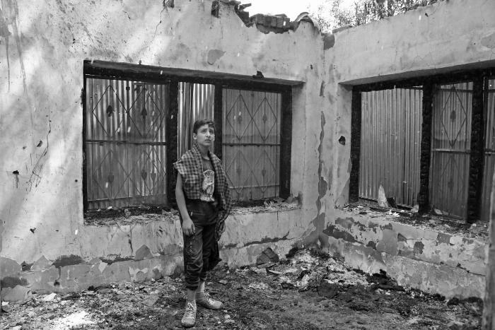 (A boy inside a house destroyed during an encounter in Pinjura village of Shopian in South Kashmir on June 8, 2020. Two houses were completely damaged during a counter-insurgency operation that resulted in the killing of four militants.) Picture: Kamran Yousuf/NewsClick