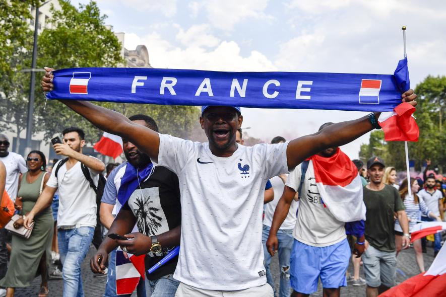 France football fan at Champs-Élysées in Paris.