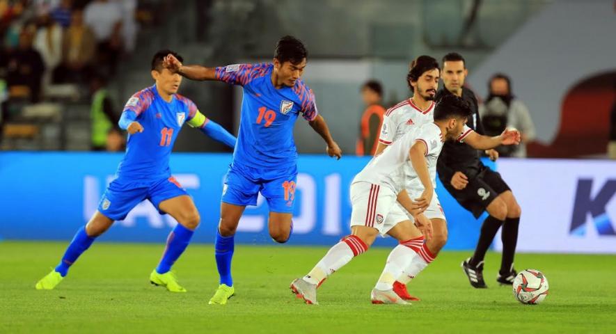 Indian football team players vie for the ball with UAE players at AFC Asian Cup