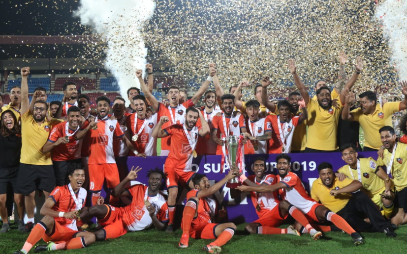 FC Goa players celebrate at the podium after winning the 2019 Hero Super Cup in Bhubaneswar