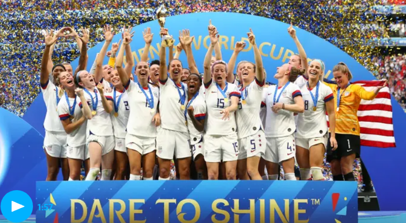 The US Women's National Football Team celebrate at the podium of the FIFA Women's World Cup
