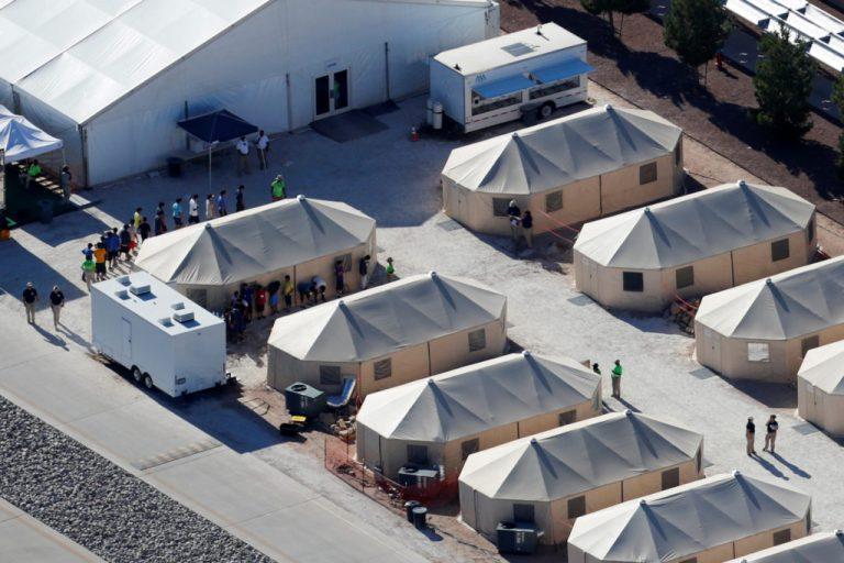 Immigrant children now housed in a tent encampment under the new "zero tolerance" policy by the Trump administration are shown walking in single file at the facility near the Mexican border in Tornillo, Texas, U.S. June 19, 2018.