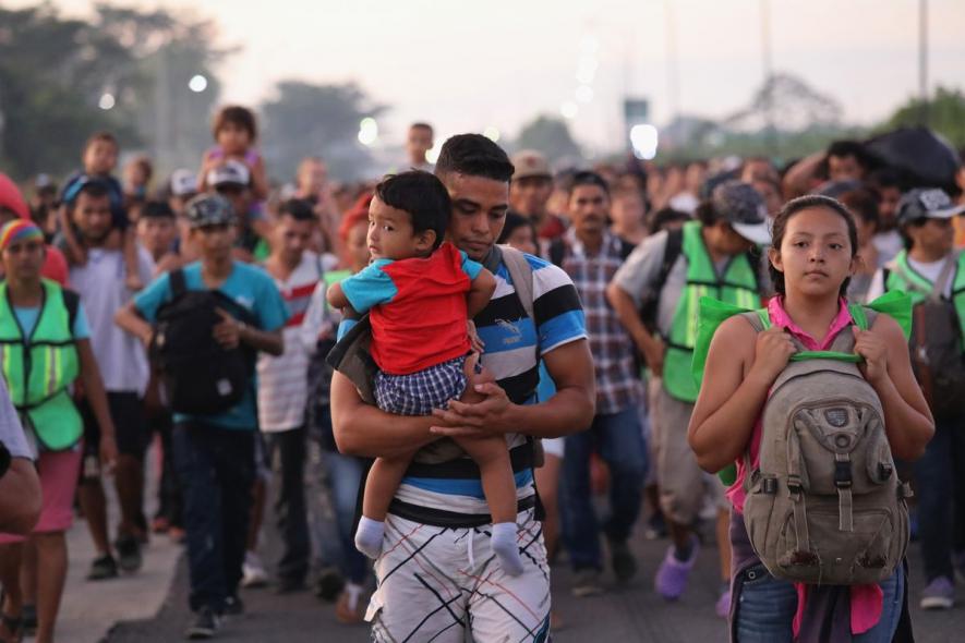 Members of a migrant caravan walk into the interior of Mexico after crossing the Guatemalan border on October 21, 2018, near Ciudad Hidalgo, Mexico.