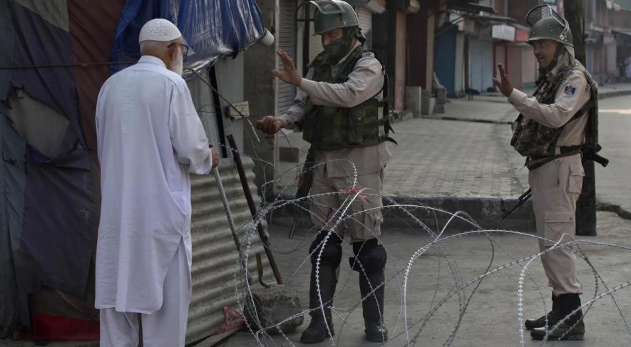 Indian forces stops an elderly person at a check point in Srinagar (Photo Dar Yasin, AP)