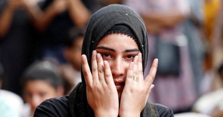 A Kashmiri woman wipes her tears while listening to a story of a Kashmiri man at a function in New Delhi where compatriots gathered to observe Eid. | Anushree Fadnavis/Reuters  