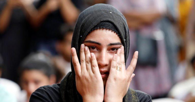 A Kashmiri woman wipes her tears while listening to a story of a Kashmiri man at a function in New Delhi where compatriots gathered to observe Eid. | Anushree Fadnavis/Reuters