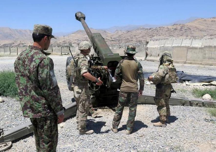 U.S. military advisers from the 1st Security Force Assistance Brigade work with Afghan soldiers at an artillery position on an Afghan National Army base in Maidan Wardak province, Afghanistan on August 6, 2018.