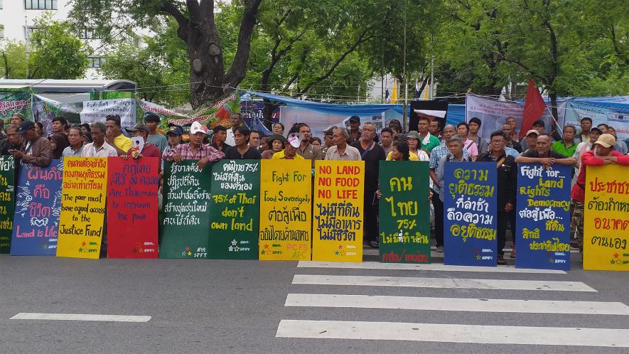 Members of various peasants' federations protest in front UN office in Bangkok.