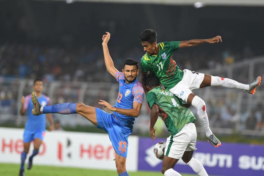 Manvir Singh of Indian football team vie for the ball with Bangladesh players in their FIFA World Cup qualifier match