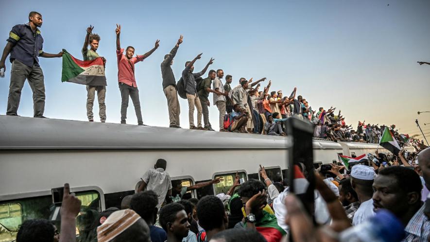 Sudanese protesters atop a train on April 23, 2019 days after Omar al-Bashir was forced to step down. Photo: Ozan Kose / AFP