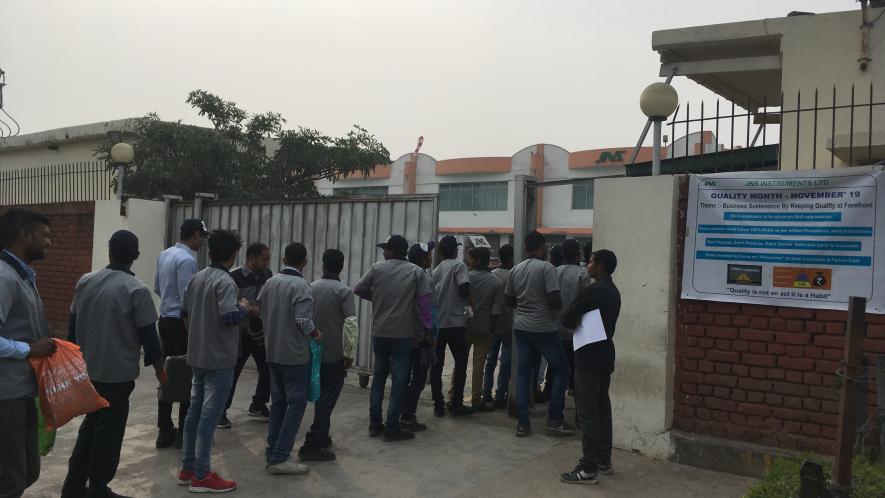 workers entering one of the manufacturing unit located in the Gurugram-Manesar industrial belt.