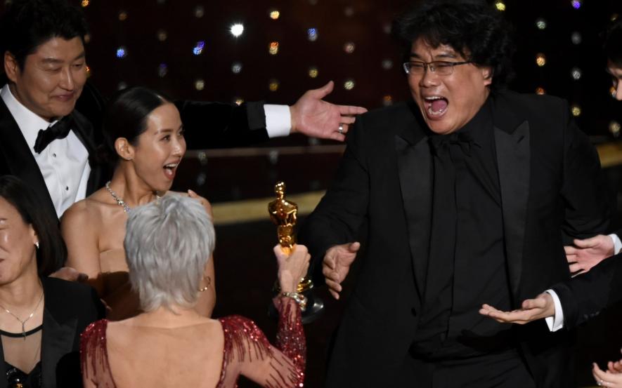 Oscars 2020: Parasite director Bong Joon Ho (right) receiving the Best Picture award