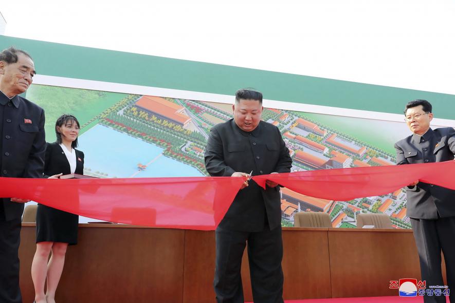 In this Friday, May 1, 2020, photo provided by the North Korean government, North Korean leader Kim Jong Un, center, cuts a tape, watched by his sister Kim Yo Jong, during his visit to a fertilizer factory in Sunchon, South Pyongan province, near Pyongyang, North Korea.