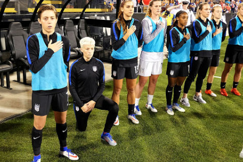 Megan Rapinoe of the US women's national team takes a knee in protest during the national anthem