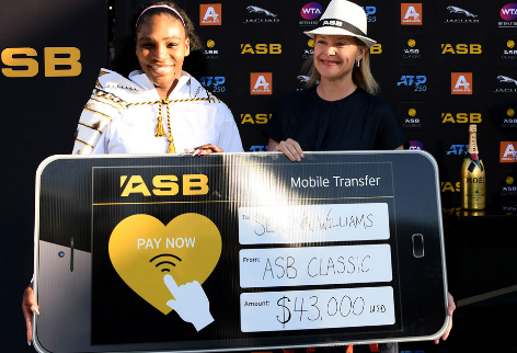 Serena Williams with her prize money cheque from Auckland Classic