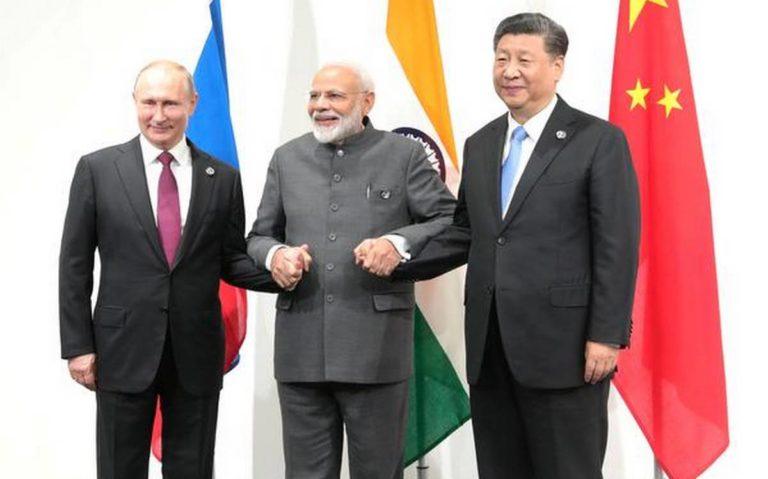 Vladimir Putin (L), Narendra Modi (C) and Xi Jinping (R) met at an informal trilateral meeting on the sidelines of the G20, Osaka, June 18, 2019