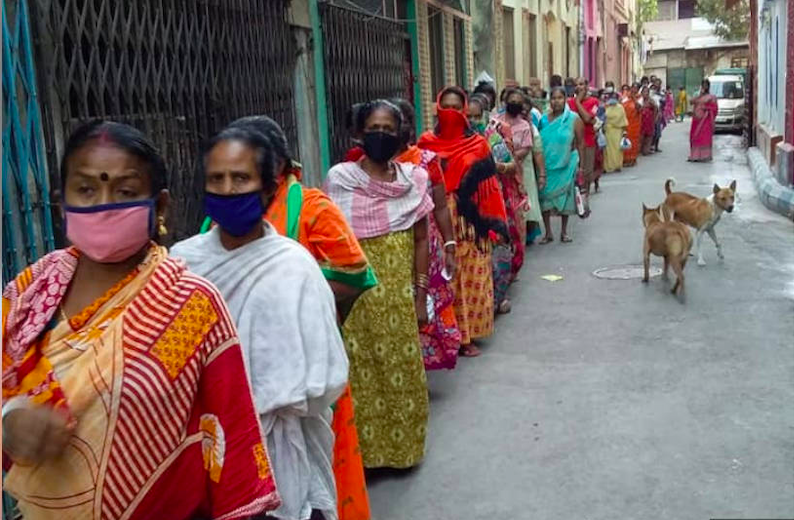 Sex workers and their families in Sonagachi, Kolkata, queue up for food rations distributed by the nonprofit New Light, on April 2, 2020.