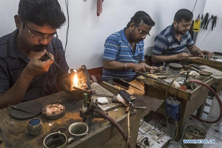 Workers make gold jewellery at a workshop in Kolkata, Workers make gold jewellery at a workshop in Kolkata. 