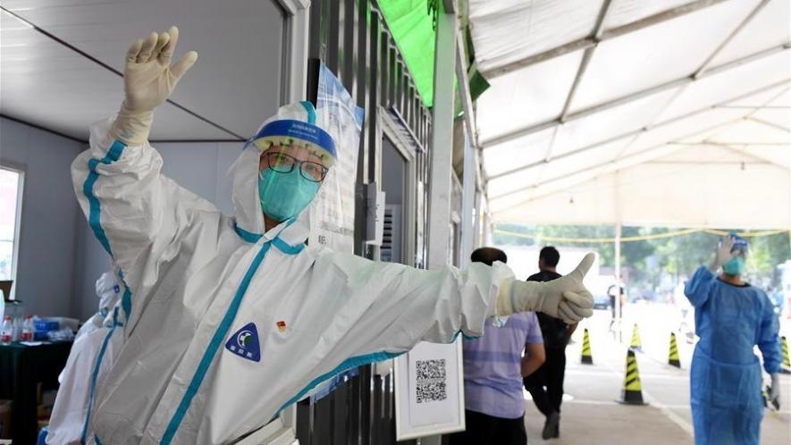 A medical worker guides people at a nucleic acid testing site in Tongzhou District of Beijing, capital of China, June 22, 2020. China contained the spread of COVID-19 to other provinces through mass testing, early lockdown measures and an overall focus on saving people's lives. Photo: Xinhua/Zhang Chenlin.