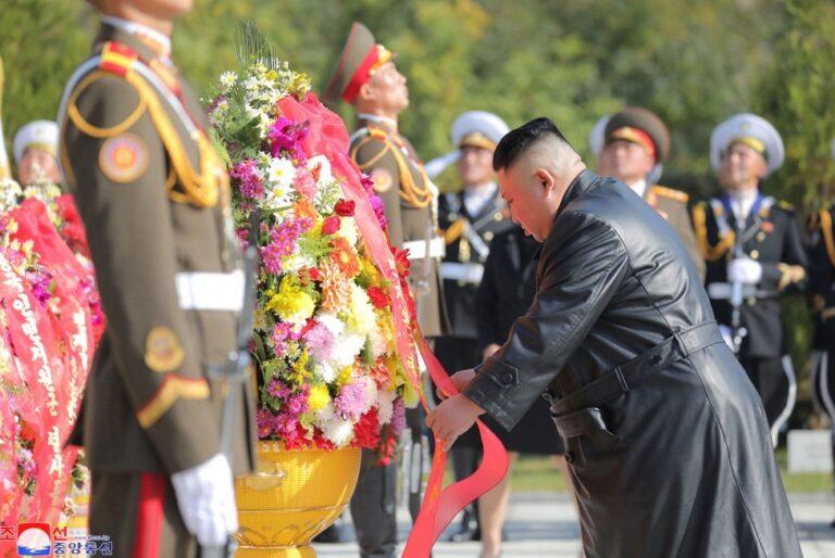 North Korean leader Kim Jong Un (R) placing wreath at monument to martyrs of Chinese People’s Volunteer Army who fought in Korean War.