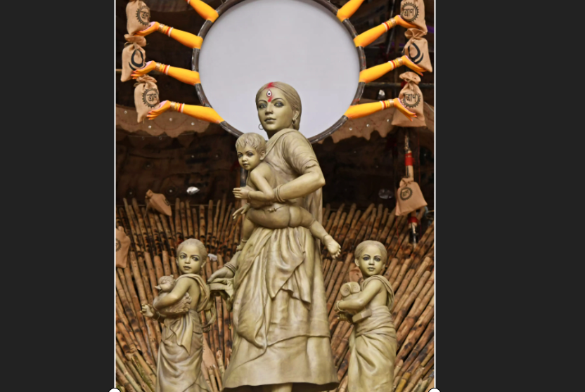 Sculpted tableau of Durga and her children as a migrant worker family