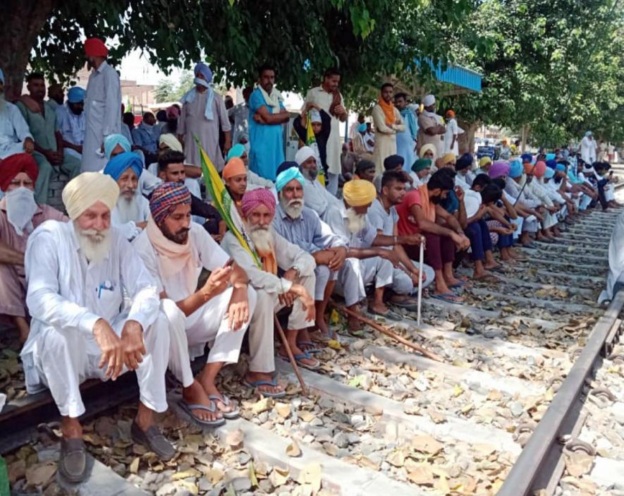 Farmers block railway track as they stage a protest against Farms bills, in Bathinda on Saturday.