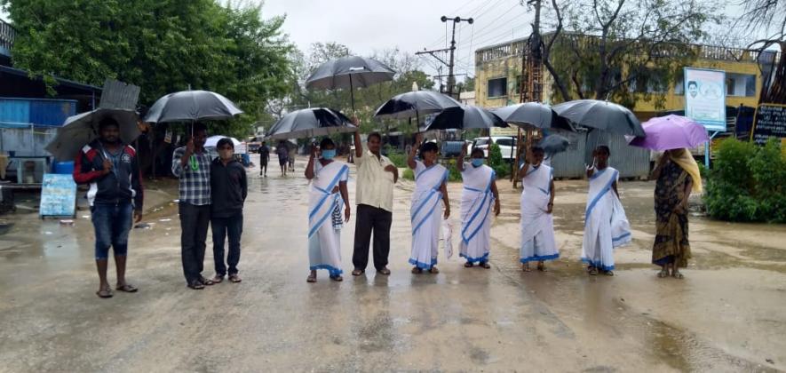 Andhra Pradesh: ASHA workers participate in the strike in Hindupur in Anantapur district amid massive rainfall.