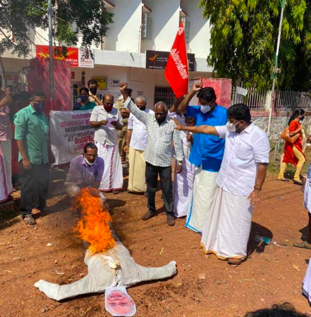 Farmers led by KK Ragesh, Rajya Sabha Member and joint secretary of All India Kisan Sabha, burn effigy of Modi in front of head post office at Kannur