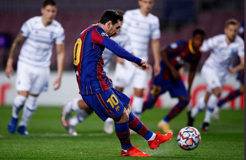 Lionel Messi of FC Barcelona scores against Dynamo Kiev