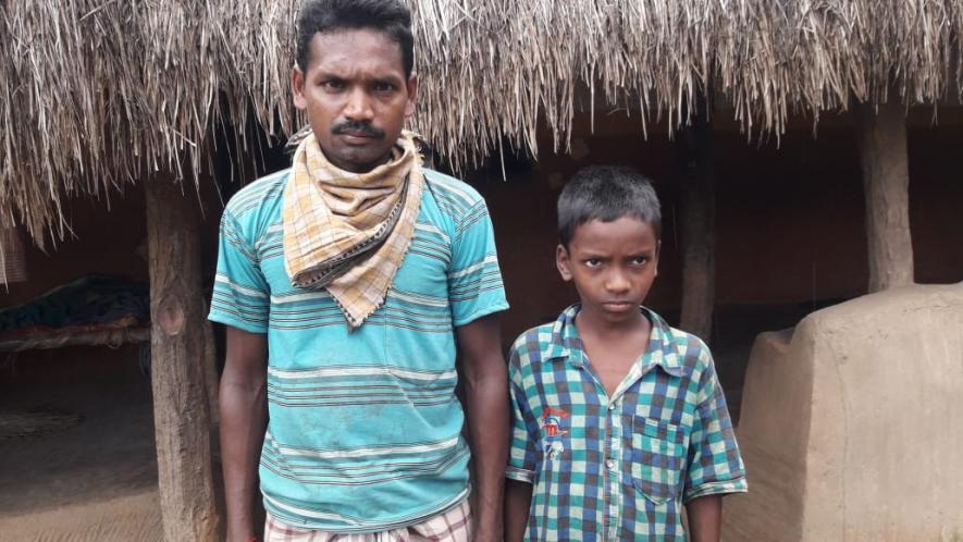 Returnee migrant worker Bhagban Hansda with his son Muchiram, he is worried about his son’s admission in the village school