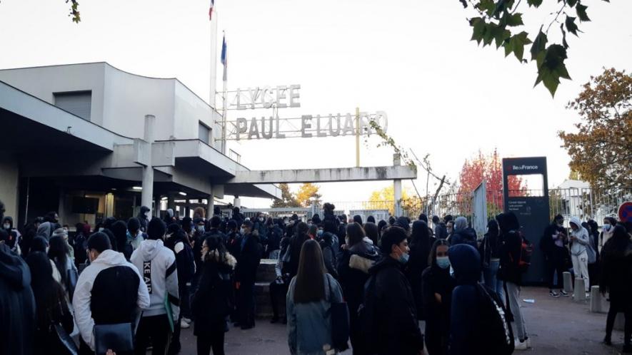 French students gather outside a high school.