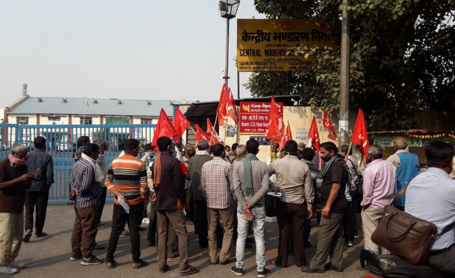 The contractual loading staff, accompanied by union members, standing outside CWC’s ICD at Patparganj in East Delhi.