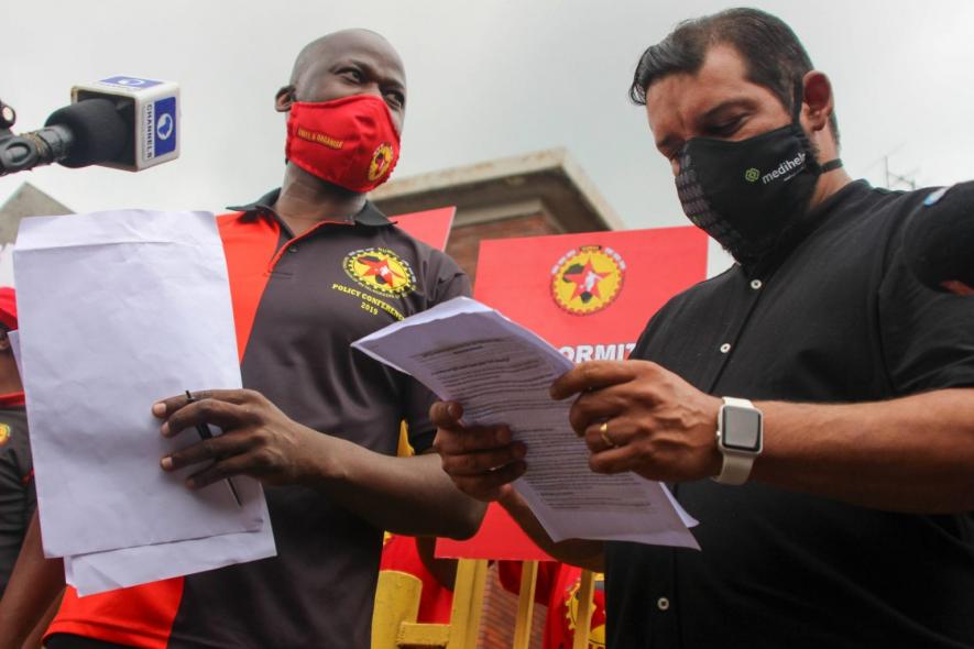 24 February 2021: From left, Numsa president Andrew Chirwa hands a list of demands regarding employees’ health and safety to ArcelorMittal chief human resources officer Sedick Achmat.