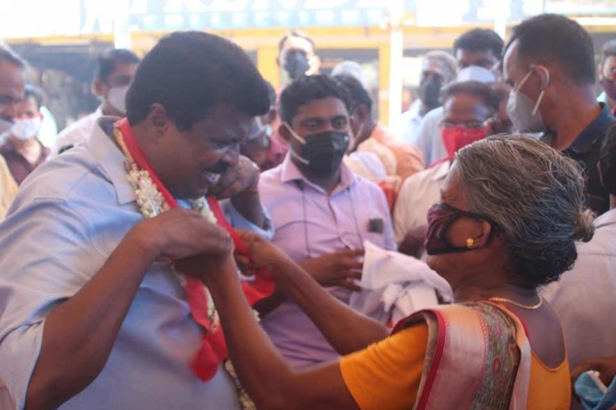 PP Chitharanjan being welcomed by a woman from the fishing community during the march.