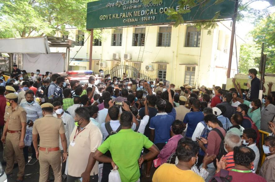 People awaiting Remdesivir medication gather as an announcement is made outside the Government Kilpauk Medical College Hospital in Chennai.