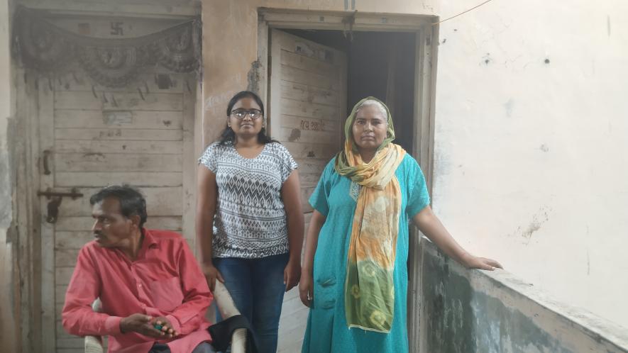 Suresh Gamit with his wife Kalawati, daughter Tejal in front of their residential quarter   