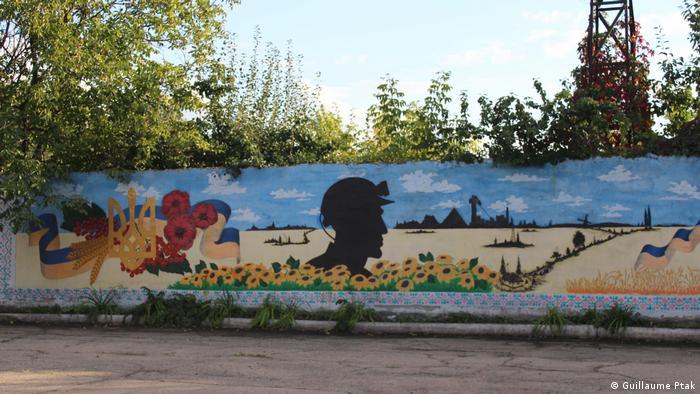 This mural honors the miners of Zolote, where a 'just transition' away from fossil fuels remains difficult