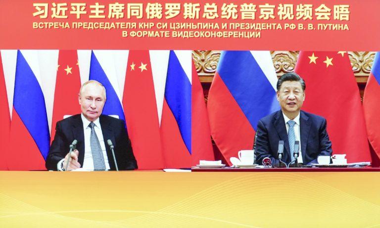 Chinese President Xi Jinping (R) met with Russian President Vladimir Putin via video link on December 15, 2001