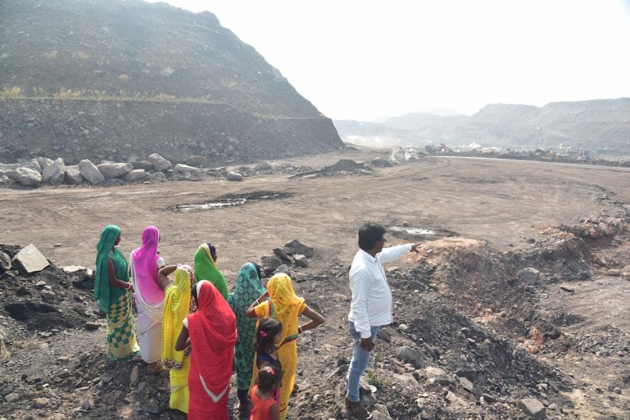 Residents of Roy Tola in Jairamdih in Dhanbad showing disputed land over which overburden is being dumped by the mines operator