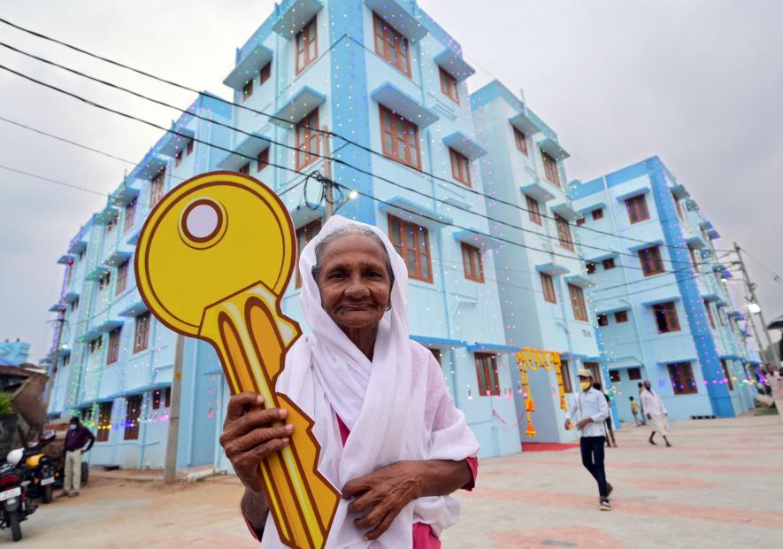 Sulaikha Beevi, who received the key from Pinarayi Vijayan, in front of the housing complex.