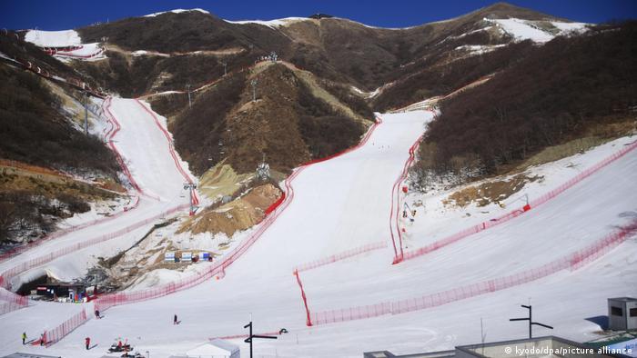 Bare mountainsides contrast with snow runs created wholly by machines for the Beijing skiing events